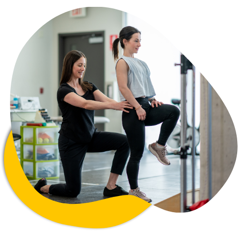 Physiotherapist assisting a patient with a knee exercise in a modern rehabilitation setting, reflecting support for allied health providers at Life Medical Imaging.