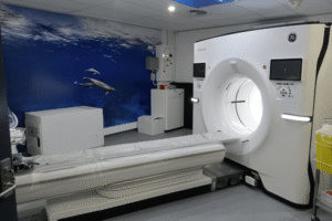 CT imaging machine in a modern medical facility with ocean-themed decor, highlighting advanced radiology services offered by Life Medical Imaging.