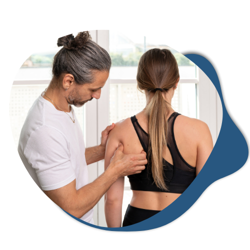 Osteopath examining a patient's shoulder for spinal and pelvic health assessment, highlighting rehabilitation and treatment support services at Life Medical Imaging.