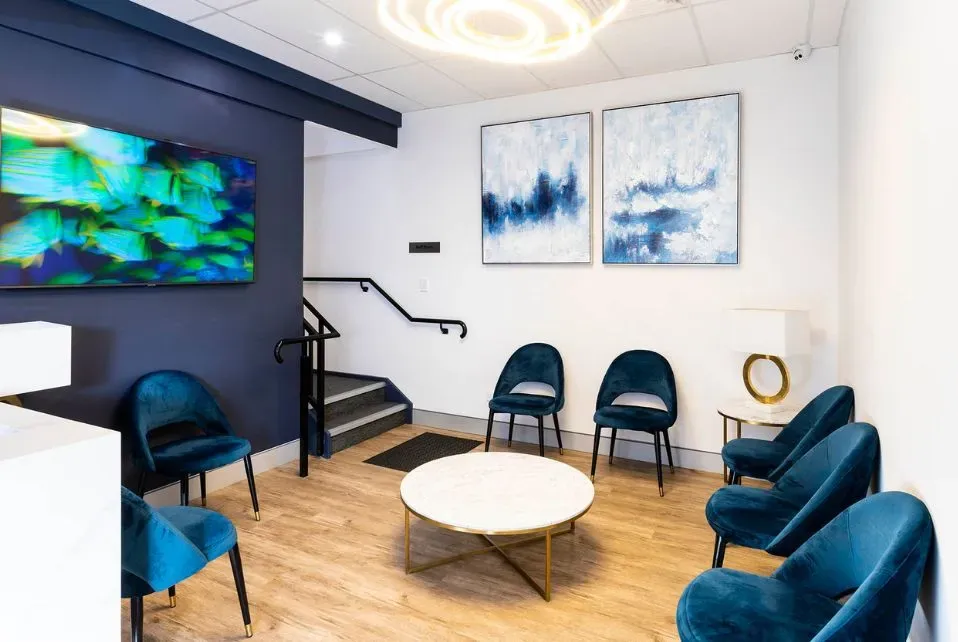 Patient holding referral and ID in a medical waiting area, emphasizing preparation for ultrasound