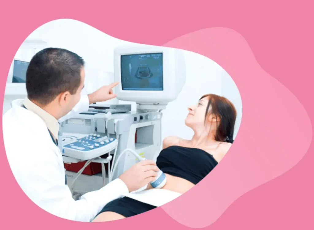 Medical professional performing an ultrasound on a pregnant woman in a clinical setting.
